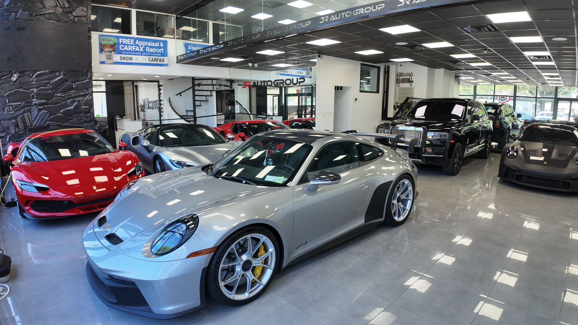 SR Auto Group showroom — luxury cars protected by Tintmax Automotive XPEL film and ceramic coating